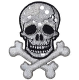 A patch featuring a skull and crossbones design with a shimmery silver finish.