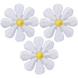 Three embroidered patches depicting white daisies with yellow centers