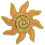 A sparkly embroidered sun applique patch with yellow and orange rays and a golden spiral center.