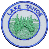 Circular white embroidered patch for Lake Tahoe, depicting a cluster of green evergreen trees against a background of blue water and soft hills.