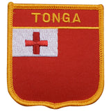 A shield-shaped embroidered patch with the text 'TONGA' and the flag of Tonga's red cross design, predominantly red with yellow edging.