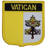 A shield-shaped embroidered patch with a yellow background and the word 'VATICAN' across the top. The patch features an emblem of the Catholic Church with a papal mitre and keys.