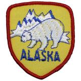 Alaska-themed patch with bear and mountains on a white background