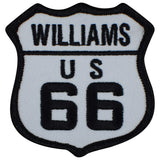 A shield-shaped patch with 'WILLIAMS US 66' text, representing a vintage Route 66 sign in black and white.